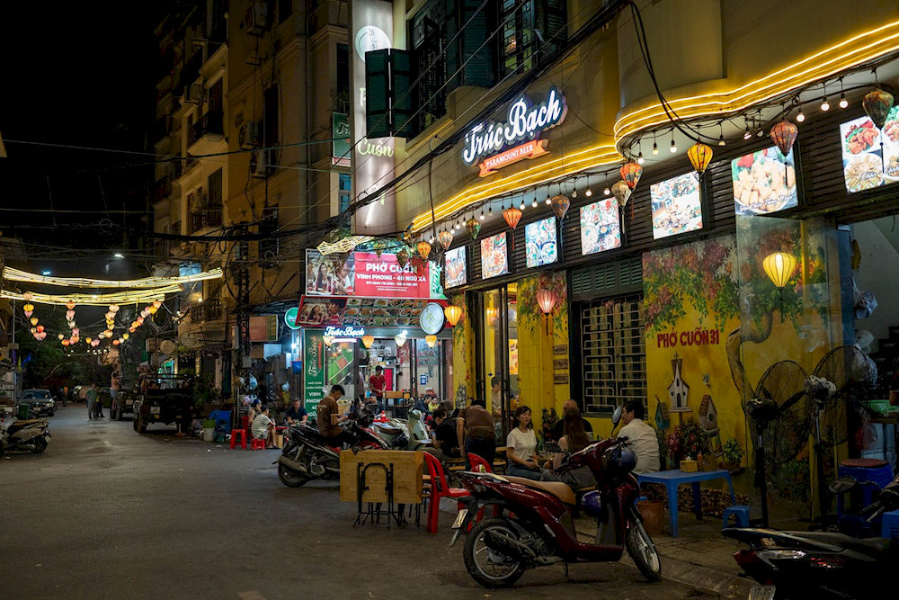 The sidewalk culinary space in Hanoi's Old Quarter exudes a rustic and welcoming charm